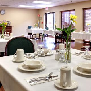A beautifully arranged dining area with elegant table settings and floral arrangements.