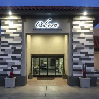A well-lit entrance to a store named 'Osborn' with modern architectural design.