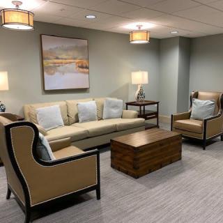 A cozy living room with comfortable seating and ambient lighting.