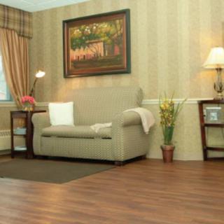 A cozy living room with a sofa, lamps, and decorative elements.