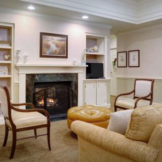 A cozy living room with elegant furniture and a warm fireplace.