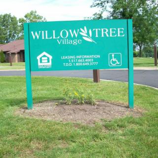 Willow Tree Village sign with leasing information and accessibility symbols.