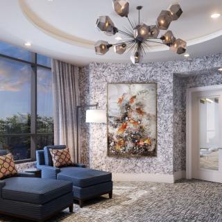 A luxurious living room with modern blue chairs, a unique chandelier, and large windows showcasing beautiful artwork on the wall.