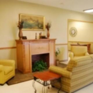 A cozy living room with a fireplace and comfortable seating.