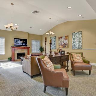 A cozy living room with comfortable seating, a fireplace, and decorative elements.