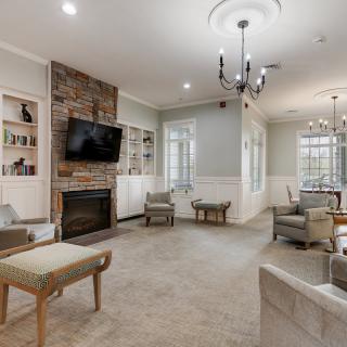 A cozy living room featuring a fireplace, TV, and comfortable seating.