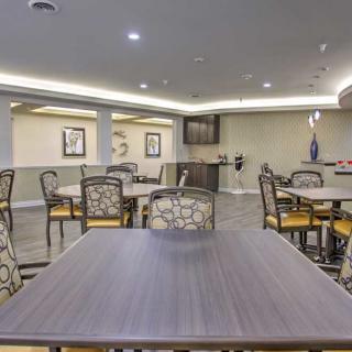A modern dining area with neatly arranged tables and chairs.