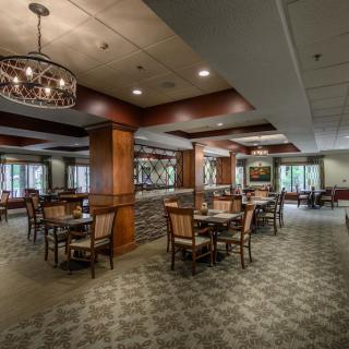 A cozy and elegantly decorated restaurant dining area with tables and chairs arranged neatly.
