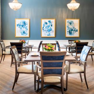 A stylish dining room featuring elegant furniture and contemporary artwork.