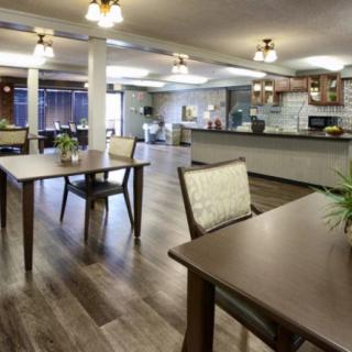 A spacious dining area with modern furniture and warm lighting.