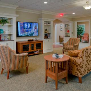 A cozy living room setup featuring comfortable seating and a television for entertainment.