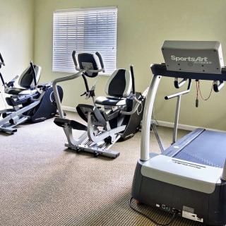 A small gym with treadmills and stationary bikes.