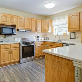 A cozy kitchen with wooden cabinets and modern appliances.