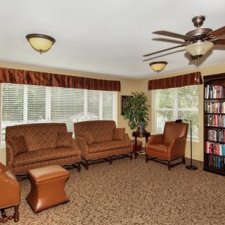 A cozy living room with comfortable seating and a well-stocked bookshelf.