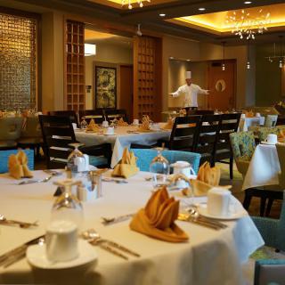 An elegantly set dining room in a luxury restaurant.