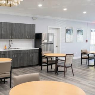 A modern kitchen and dining area with sleek furniture and open space.