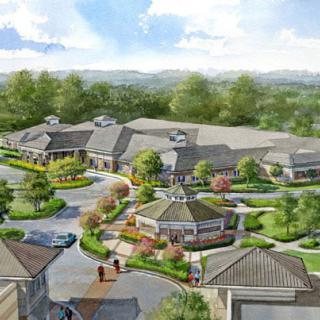 An aerial view of a well-planned residential complex surrounded by lush greenery.