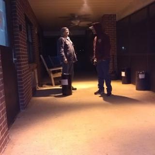 A tense moment captured in the dimly lit hallway.