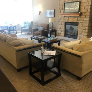 A cozy living room with sofas, a coffee table, and a fireplace.