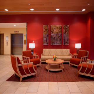 A cozy and modern lobby featuring comfortable seating and a warm color palette.
