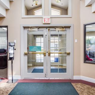 A welcoming entrance with glass double doors leading to an interior space.