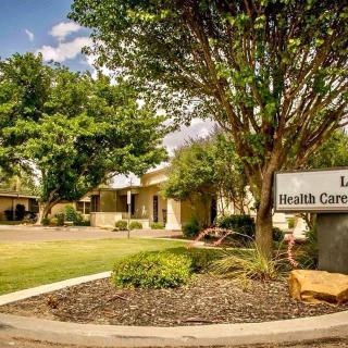 Exterior view of a health center with landscaping and signage.