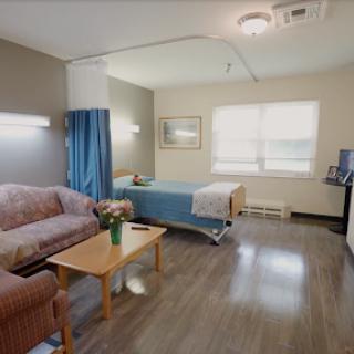 A comfortable and well-lit hospital room designed for patient care.