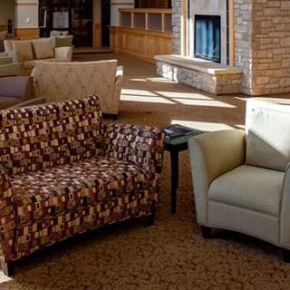 A cozy seating area in a modern lobby with comfortable chairs and inviting decor.