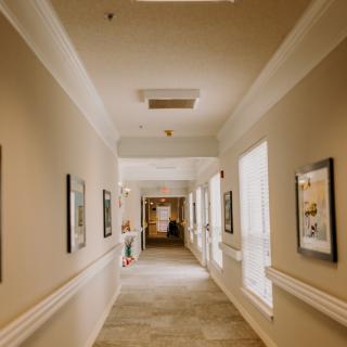 A well-lit hallway adorned with framed pictures on the walls.