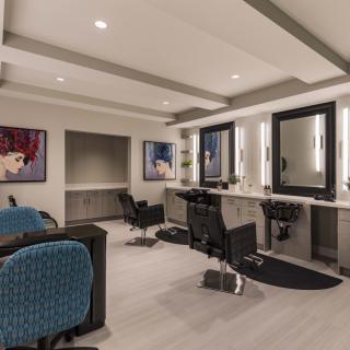 A modern hair salon interior with stylish decor and comfortable seating.