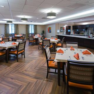 A neatly arranged dining area with decorated tables and chairs.