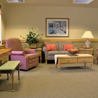 Cozy living room with pastel furnishings and decorative accents.