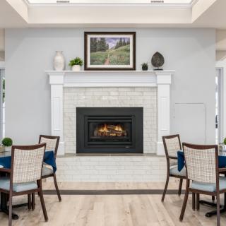 A modern dining area featuring a cozy fireplace and elegant decor.