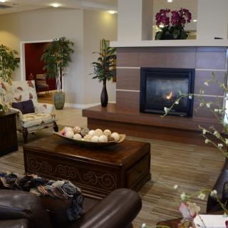 A cozy living room with modern decor and a warm fireplace.