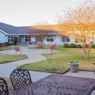A peaceful courtyard with seating areas and a well-maintained garden.