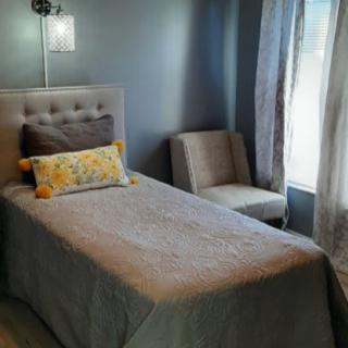 A cozy bedroom with a single bed and modern decor.