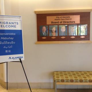 A welcome sign for a conference stands in a hallway near the board of directors' display.