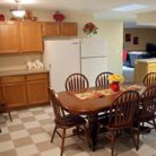 A cozy kitchen with a dining area and wooden furniture.
