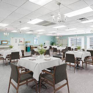A modern dining room with elegantly set tables and stylish chairs, designed for a comfortable dining experience.