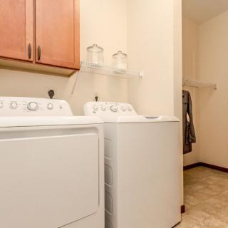 A well-organized laundry room with a washer and dryer.