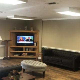 A cozy living room with a television and comfortable seating.