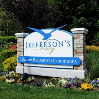 A welcoming sign for Jefferson's Berry Leisure Retirement Community, surrounded by vibrant flowers and greenery.