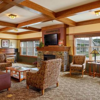 Cozy living room with a fireplace, TV, and comfortable seating.