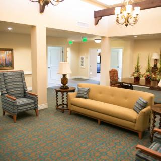 A cozy living room with comfortable seating and warm lighting.