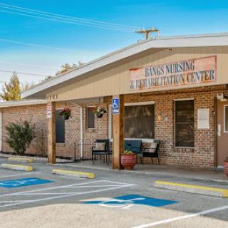 A brick exterior building with signage, featuring accessible parking spaces.