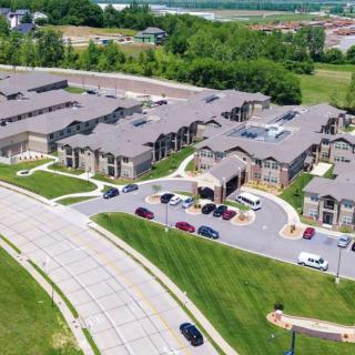Aerial view of a suburban housing complex with landscaped surroundings.