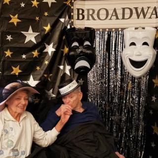 A joyful moment captured with friends against a Broadway-themed backdrop.