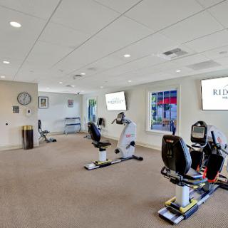 A well-equipped fitness studio featuring recumbent bikes and ample workout space.