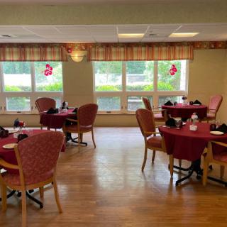 A warm and inviting dining area with red tablecloths and festive decorations.