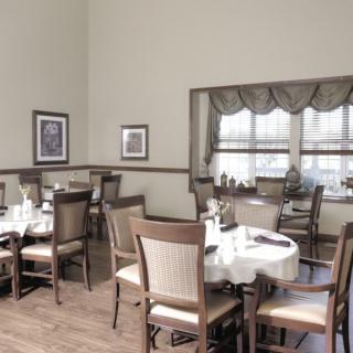 A cozy dining room with neatly arranged tables and chairs.